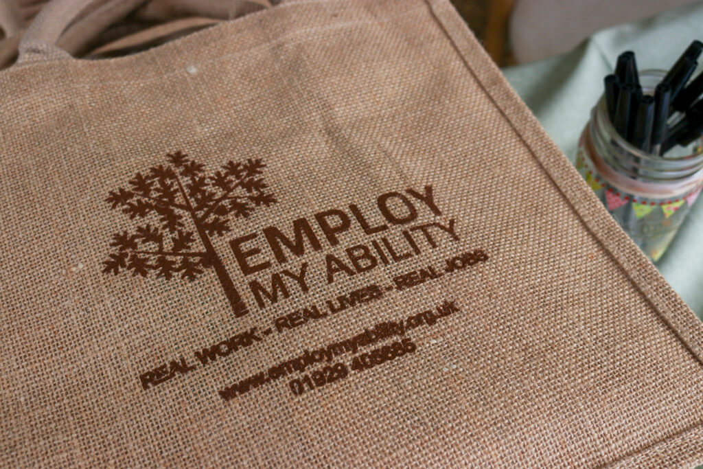 EMA Open Day - 17 May 2022, Employ My Ability handbags and pens for sale.