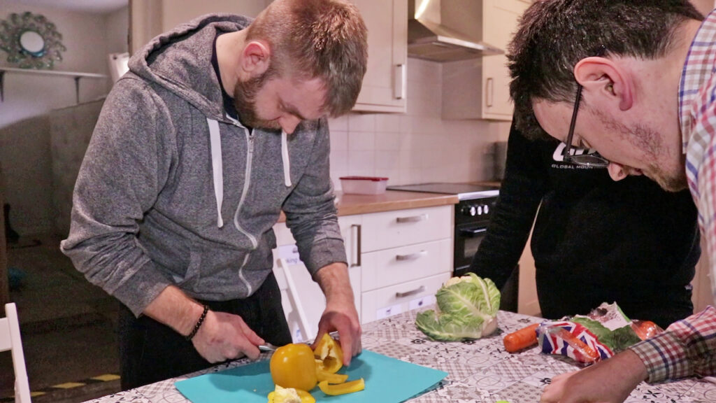 Two students and a tutor doing kitchen social care.