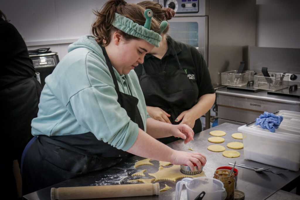 one student cooking at ema gillingham, presumably doing biscuits